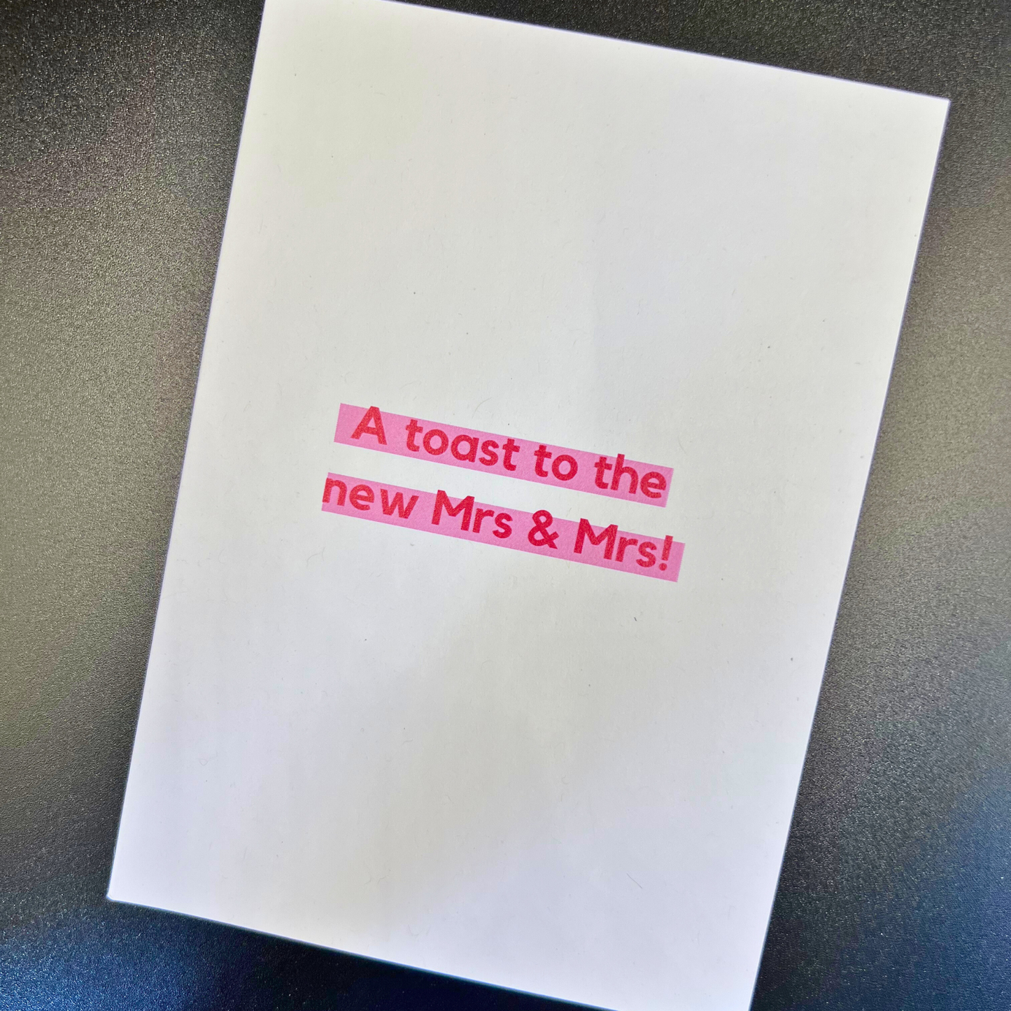 White lesbian wedding greeting card by The Mail Minx with red text 'A toast to the new Mrs & Mrs!'