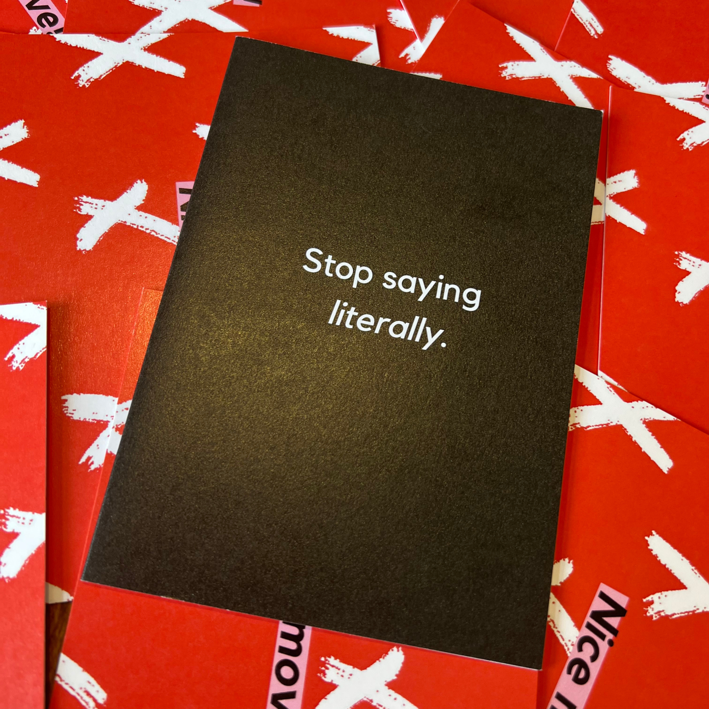 A black greeting acrd designed by The Mail Minx that says stop saying literally in white text