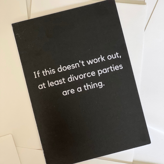 A black greeting card that says "If this doesn't work out, at least divorce parties are a thing" by The Mail Minx