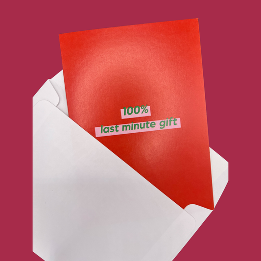A red greeting card by The Mail Minx with a message saying "100% last minute gift" in green text, highlighted in pink - card is popping out of a white envelope