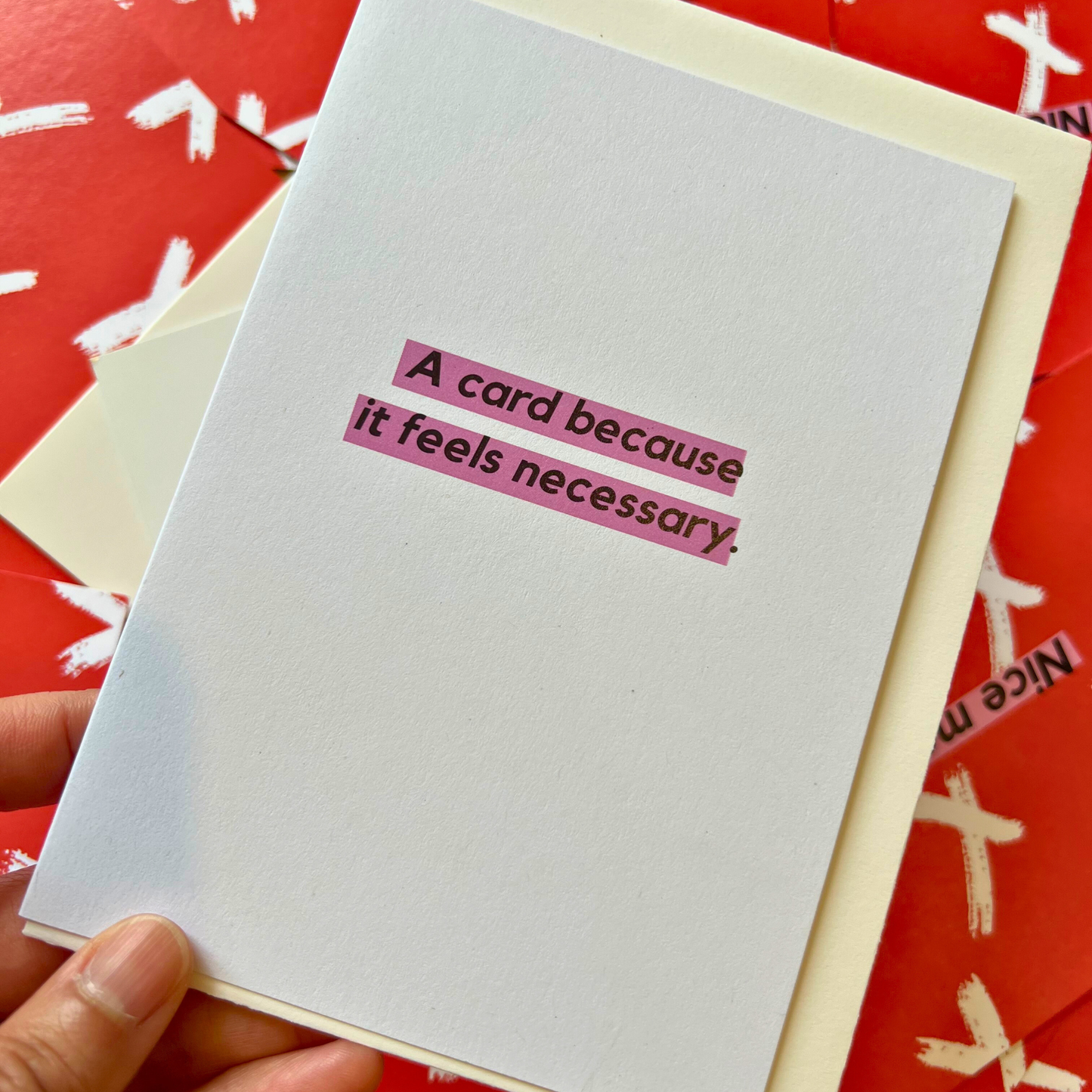 A white greeting card designed by The Mail Minx that says "A card because it's neccessary"