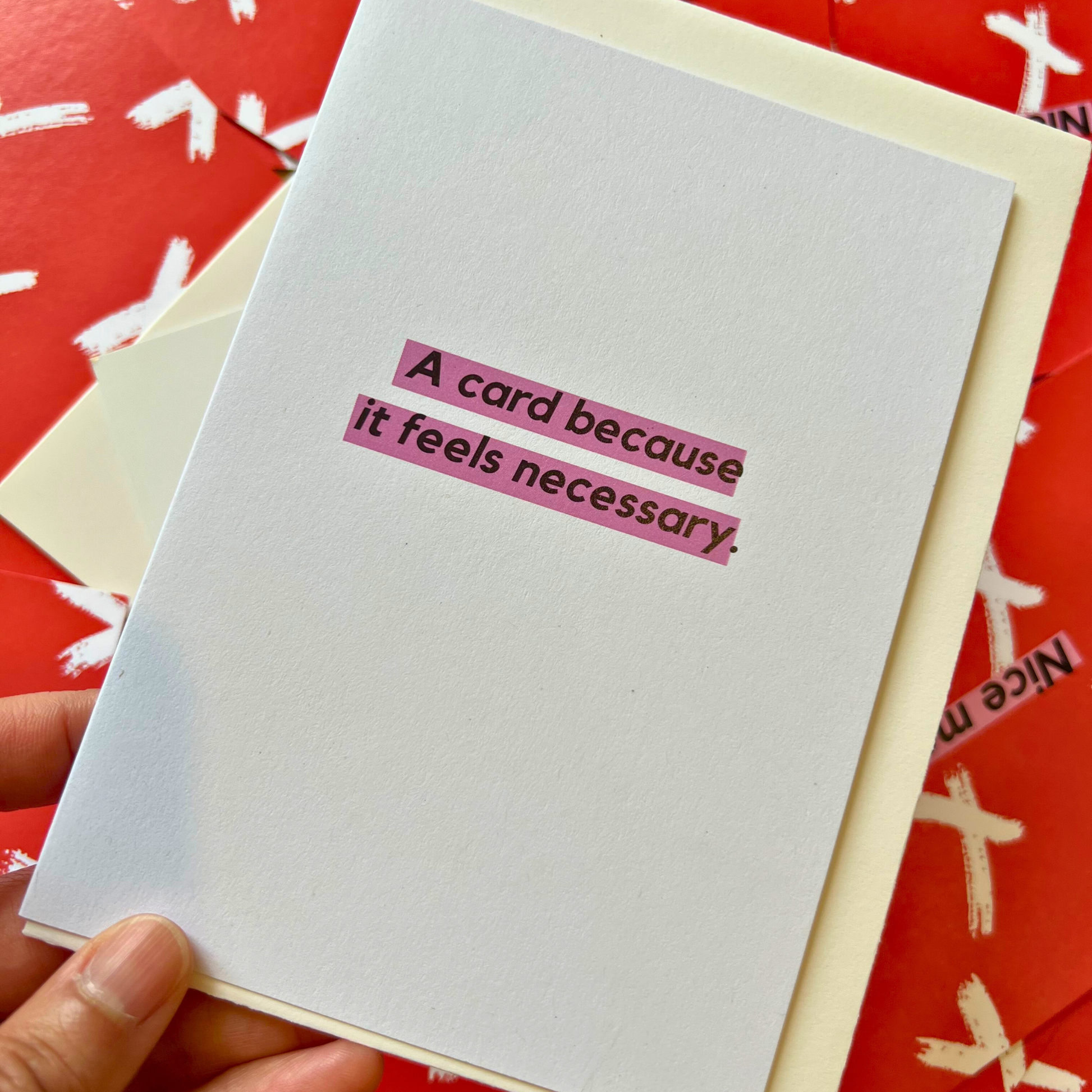 A white greeting card designed by The Mail Minx that says "A card because it's neccessary"