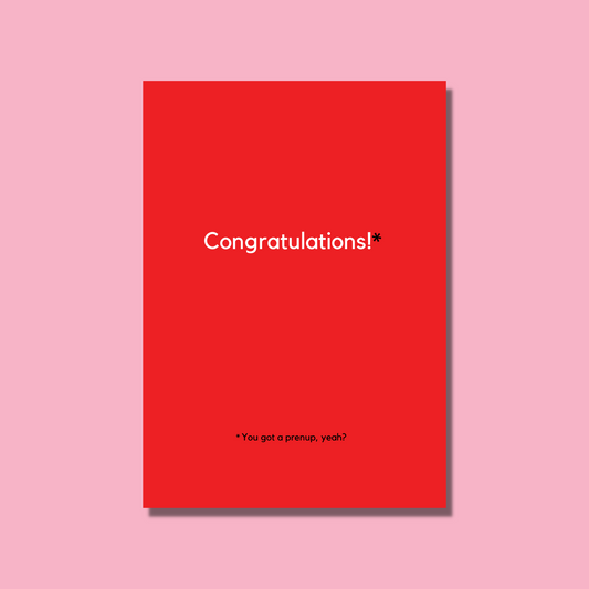 This a bitchy wedding card that says "Congratulations - you got a prenup, yeah?" The card is red with white and black text.