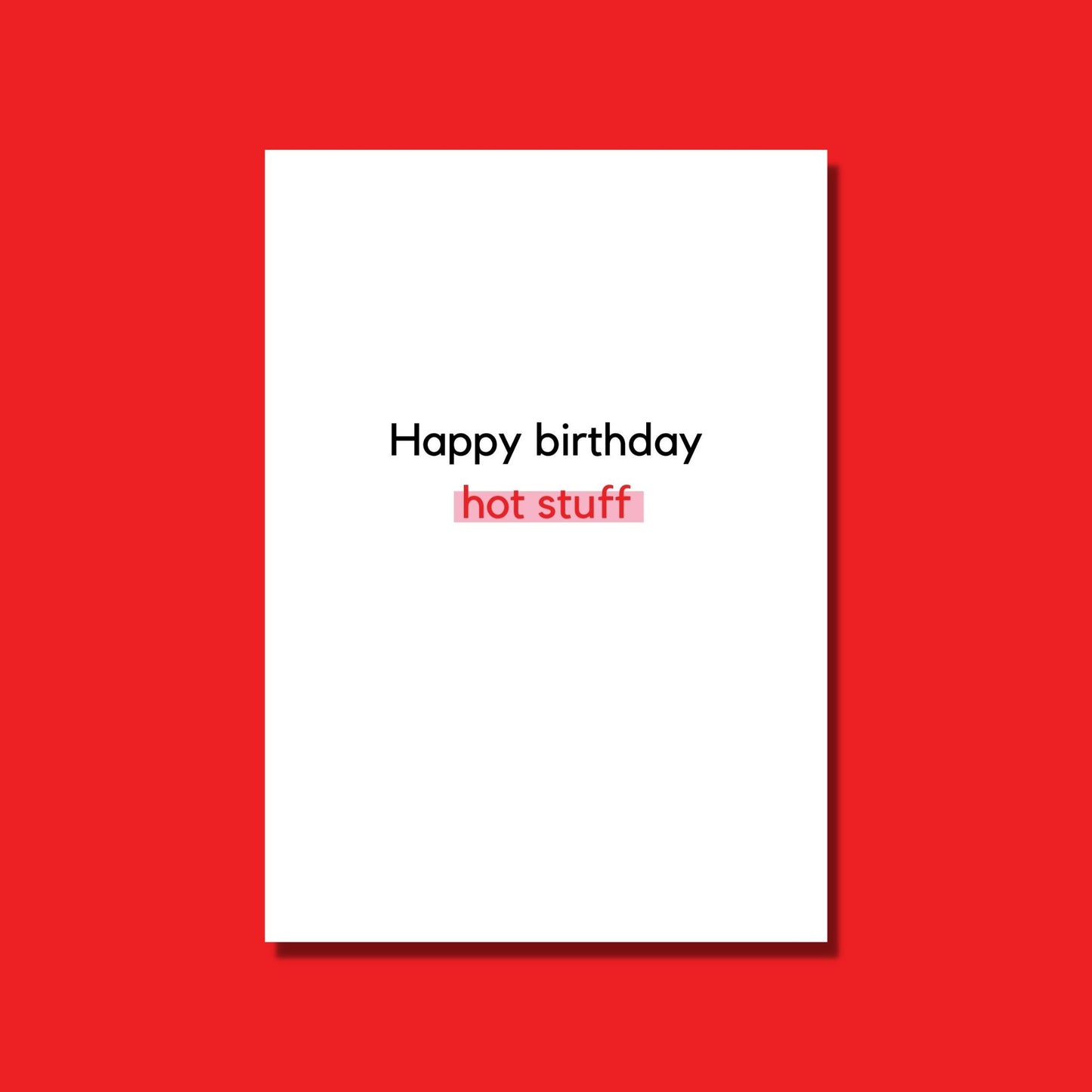 A funny birthday card that is white with black and red text that says "Happy Birthday hot stuff" highlighted in pink.
