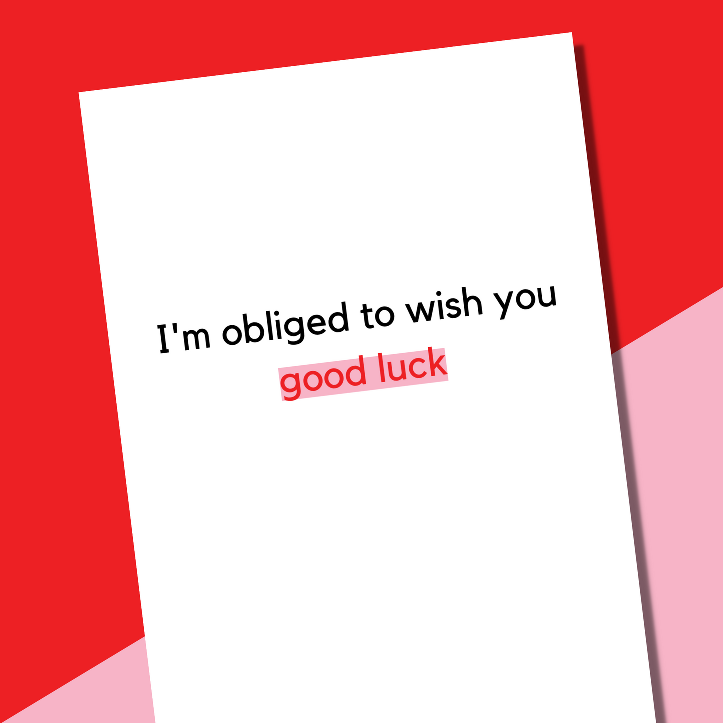 A sassy card that is white with black and red text that says "I'm obliged to wish you good luck"